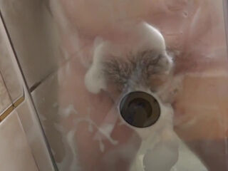 Pregnant milf in the lather in the shower masturbates with a dildo. Rubber dick fucks hairy pussy.