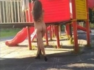 'Beautiful, young exhibitionist girl shows off her beautiful body on the Playground'