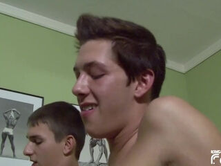 Two twinks get their big dicks sucked on the bed by older man